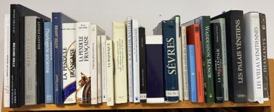 many books that are on a wooden shelf
