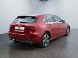 the rear end of a red mercedes cla parked in a white room