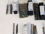 a lot of drill bits that are sitting on a table