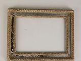 an old picture frame hanging on a wall with a white background