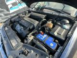 a car that has a blue battery in it ' s hood