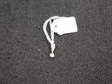 a white tag on a black surface with a white cord