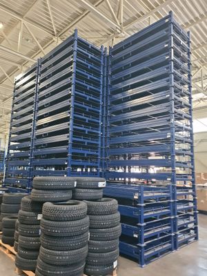 several stacks of tires are stacked on pallets in a warehouse