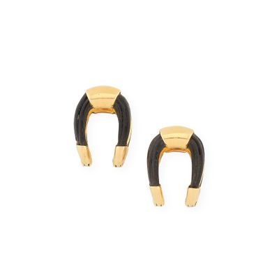 a pair of black and gold horseshoe earrings on a white background