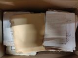 a box full of papers and papers sitting inside of it