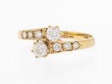 an image of a gold ring with three white stones