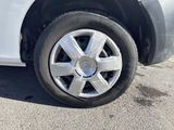 a white car that is parked on the side of the road