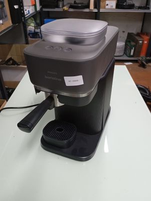 a coffee maker sitting on a table in a room