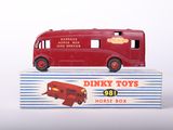 a red toy bus sitting on top of a box