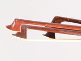 a violin bow with a wooden handle on a white background