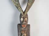an image of a wooden sculpture of a man with a tennis racket in his hand