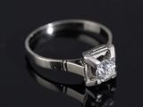 a close up of a diamond ring on a black surface