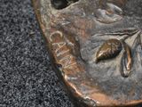 a close up of a bronze statue of a woman