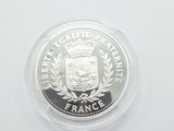the coin is in a clear plastic container on a white surface