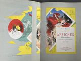 an open book with a picture of a woman in a red dress and a man in a red cape