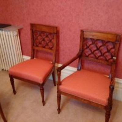 two chairs in a room with a radiator and a radiator