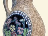 a small vase with a floral design on it