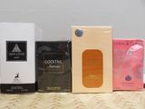 several different types of perfumes are lined up on a wicker table