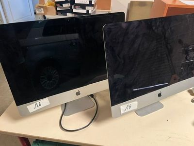 two computer monitors sitting on top of a desk
