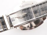 a close up of a watch on a white surface
