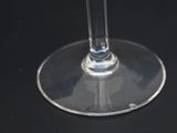 a glass of wine sitting on a black table