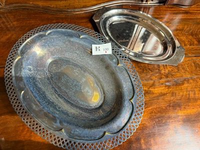 a silver plate on a table next to a mirror