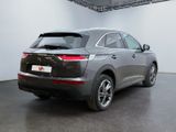 the rear end of a grey suv parked in a garage