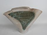 a white vase with a green design on it