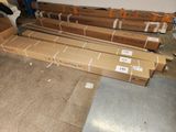 many boxes of cardboard sitting on the floor in a room