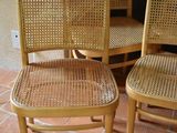 four chairs that are sitting on a tile floor