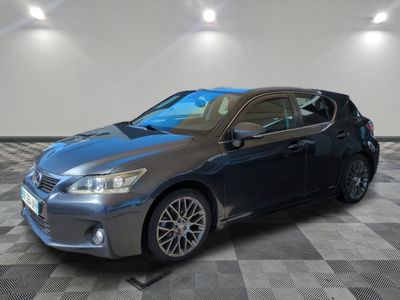 a gray car is parked on a checkered floor in a garage