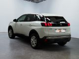 the rear end of a white car parked in a garage