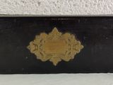 a black and gold purse sitting on a white table