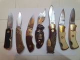 several different types of knives are lined up on a piece of paper