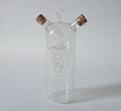 a glass bottle with a bunch of grapes inside of it