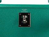 a close up of a green leather handbag on a white background
