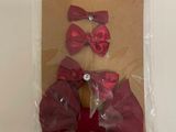 a package with a teddy bear wearing a red bow