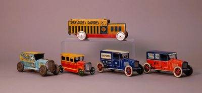five toy cars that are lined up in a row