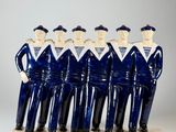 five figurines of men dressed in blue uniforms