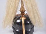 a black helmet with a gold sword on top of it