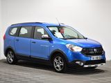 the small blue car is parked in a room with a checkered floor