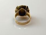 an image of a gold ring with a black stone in the center