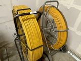 two yellow hoses sitting on a cart in a room