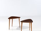 a pair of side tables in the style of person