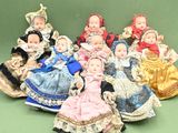 a group of dolls that are sitting on a green surface