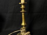 an antique brass table lamp with a rope wrapped around the base