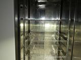 a glass door in the middle of a stainless steel refrigerator