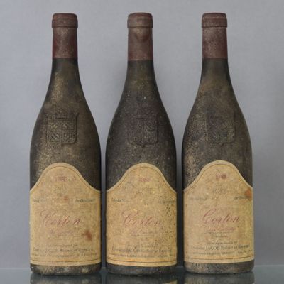 three bottles of wine sitting on top of a table next to each other