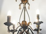 a chandelier with three lights hanging from it ' s ceiling