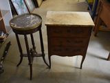 a small table with a marble top next to a small table with a marble top
